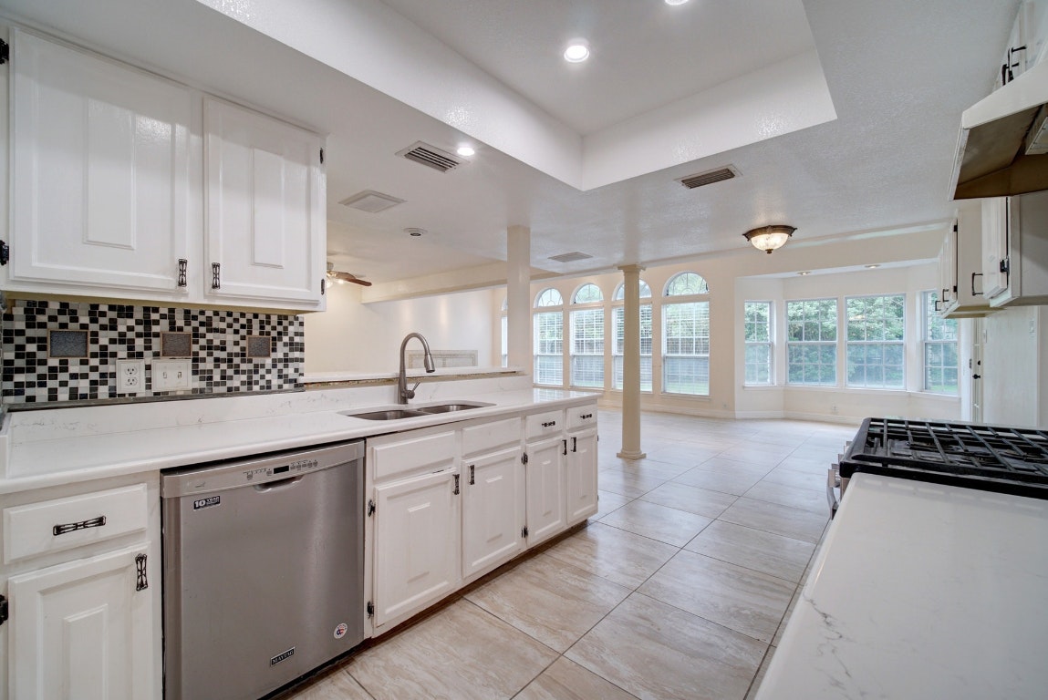 10509 Doering Lane Austin, TX 78750 - Photo 32 of 36 a kitchen with granite countertop a sink and a stove top oven