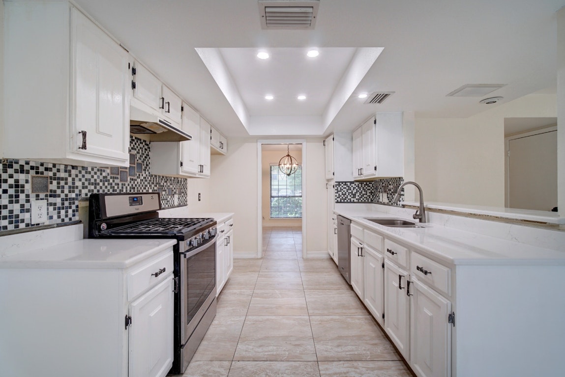 10509 Doering Lane Austin, TX 78750 - Photo 4 of 36 a kitchen with stainless steel appliances a sink stove and cabinets