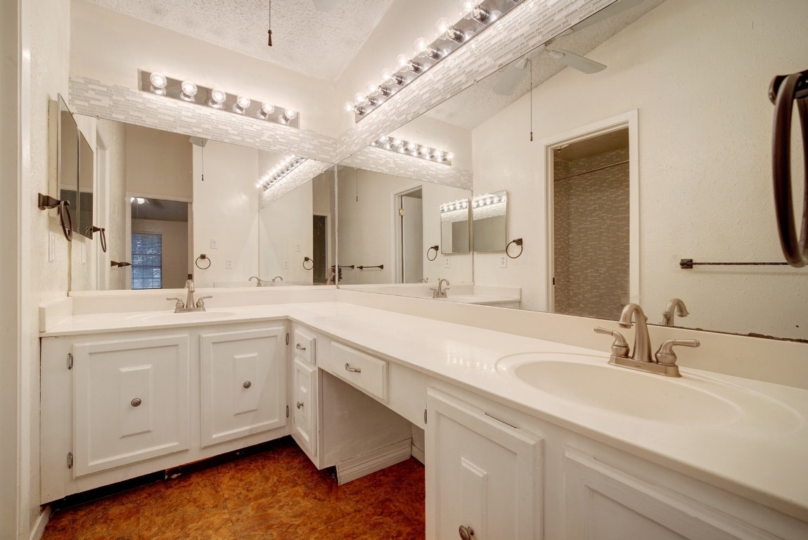 10509 Doering Lane Austin, TX 78750 - Photo 10 of 36 a spacious bathroom with a double vanity sink and a mirror
