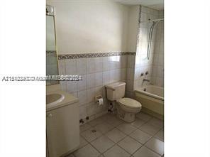 Surfside Surfside, FL 33154 - Photo 8 of 9 a bathroom with a toilet a sink and a window