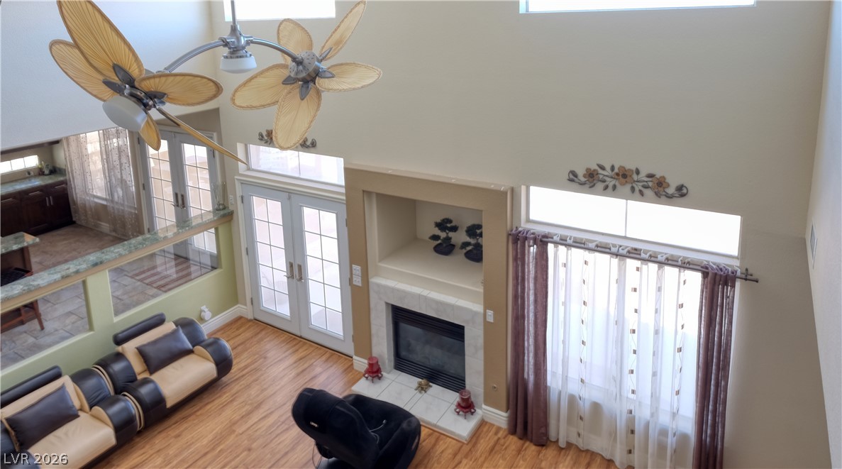 3704 North Campbell Road Las Vegas, NV 89129 - Photo 21 of 46 Lofty ceilings crown this gathering space, featuring elegant French doors and a cozy fireplace.
