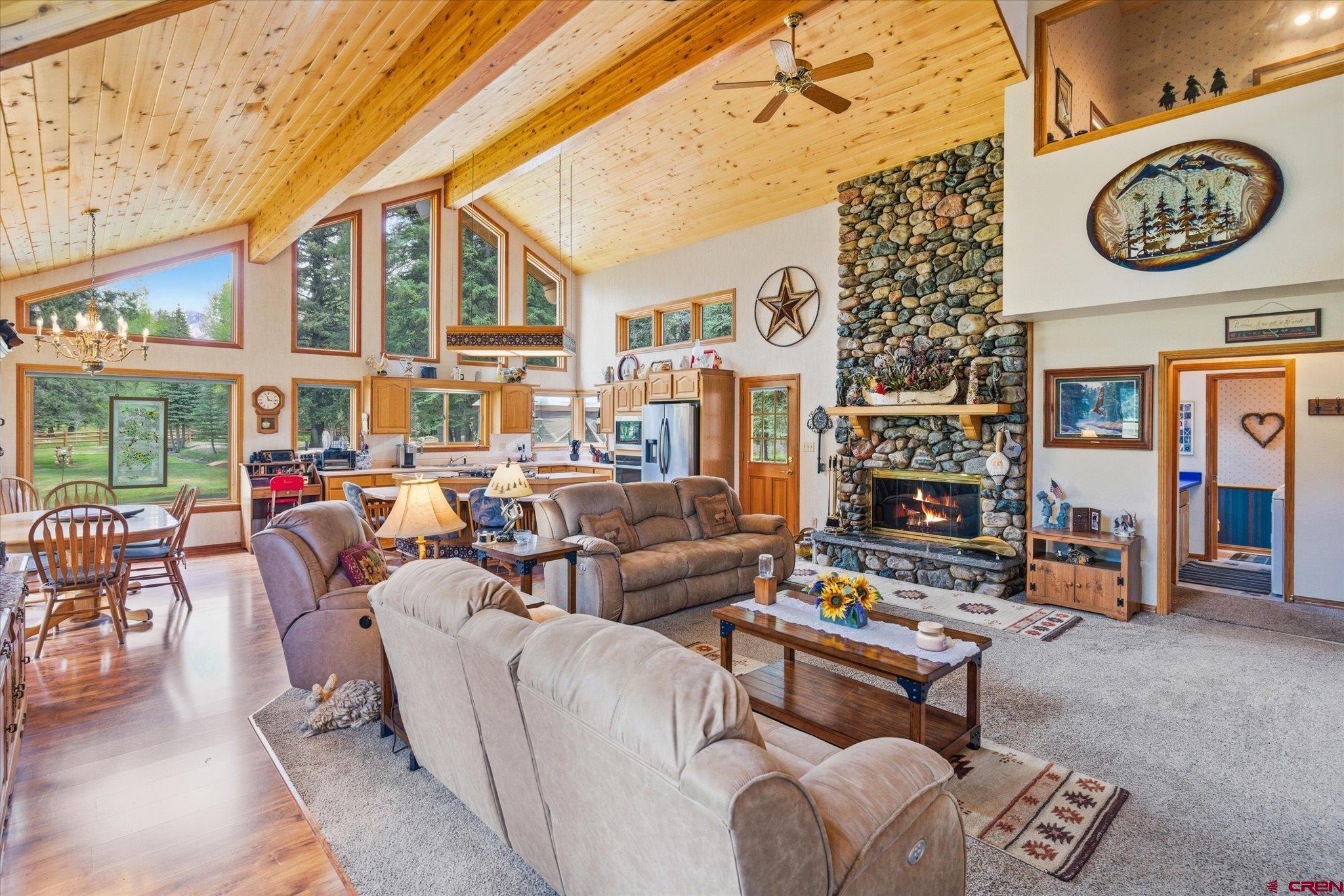 197 Hummingbird Way Bayfield, CO 81122 - Photo 8 of 44 a living room with furniture a fireplace and a table
