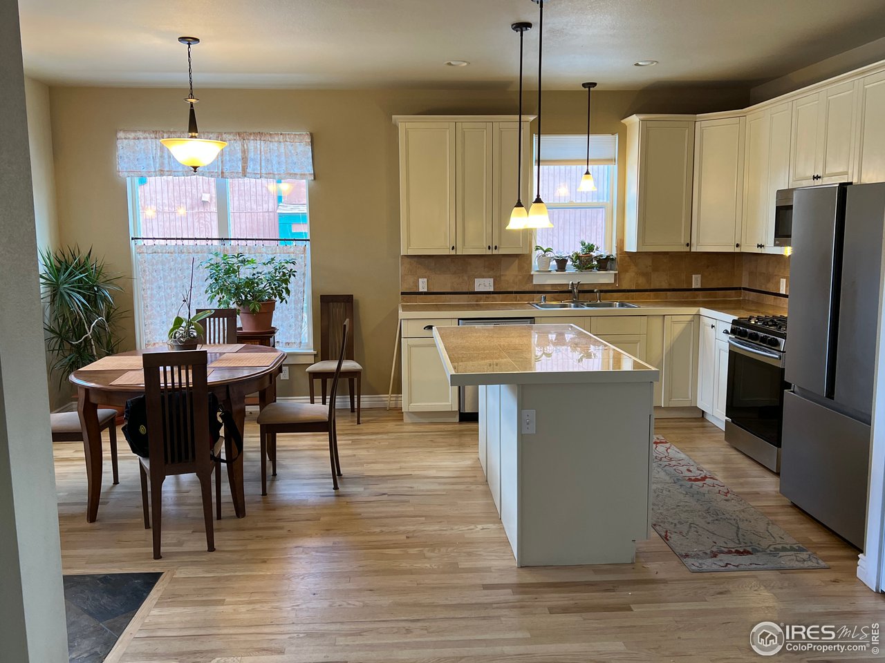 722 East Baseline Road Lafayette, CO 80026 - Photo 8 of 24 a kitchen with kitchen island granite countertop a stove a sink a center island and cabinets