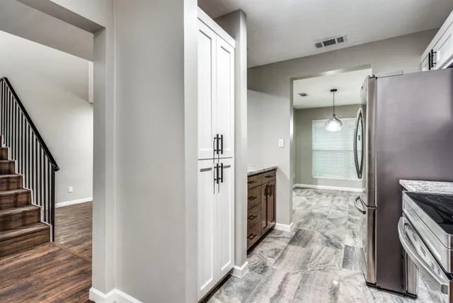 a view of a kitchen from a hallway