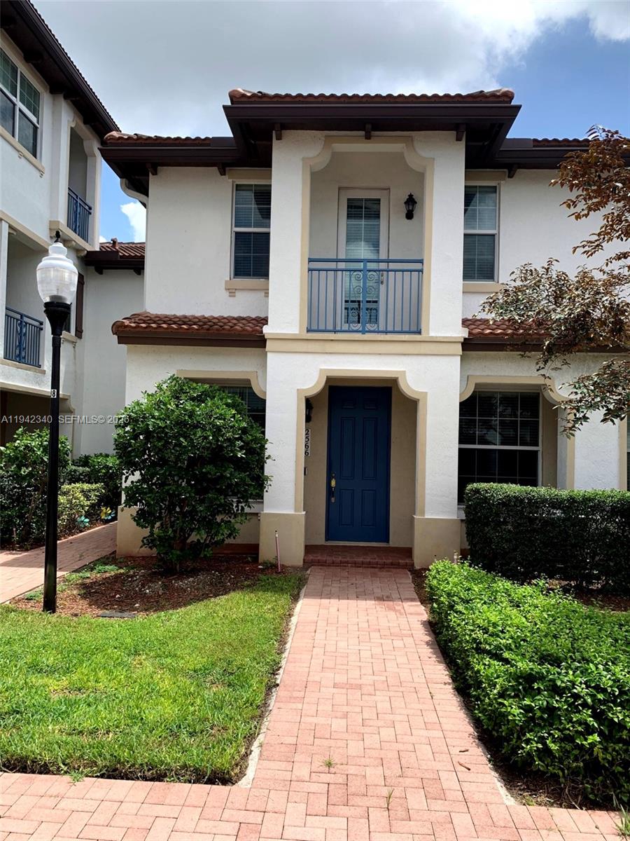 2566 Southwest 119th Way, Unit 3911 Miramar, FL 33025 - Photo 2 of 11 a front view of a house with a yard