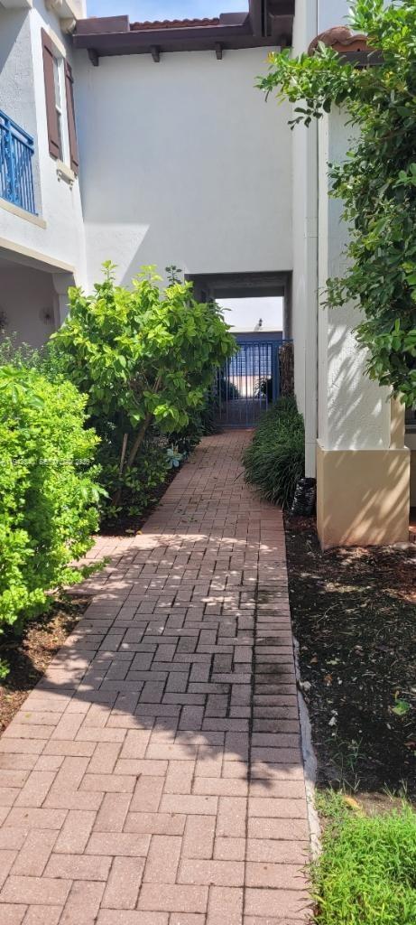 2566 Southwest 119th Way, Unit 3911 Miramar, FL 33025 - Photo 3 of 11 a view of a pathway both side of the house