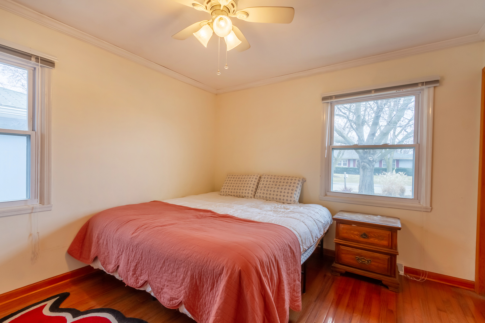 800 Orchard Road Montgomery, IL 60538 - Photo 10 of 21 a bedroom with a bed and wooden floor