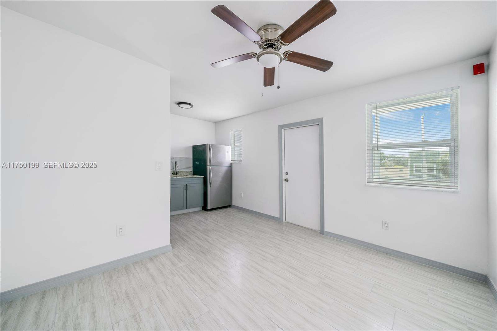 1281 Northwest 61st Street, Unit 2 Miami, FL 33142 - Photo 4 of 13 wooden floor in an empty room with a window