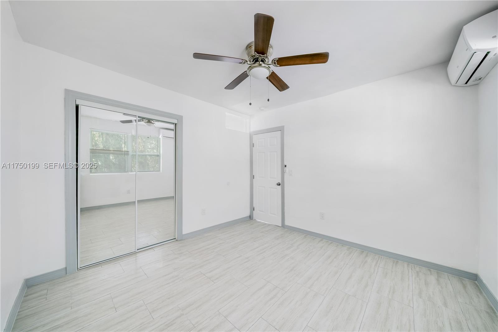 1281 Northwest 61st Street, Unit 2 Miami, FL 33142 - Photo 8 of 13 a view of an empty room with a window