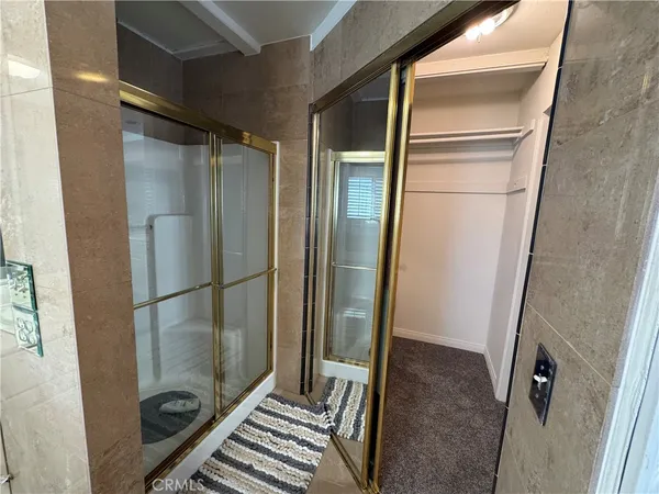 a bathroom with a glass shower door