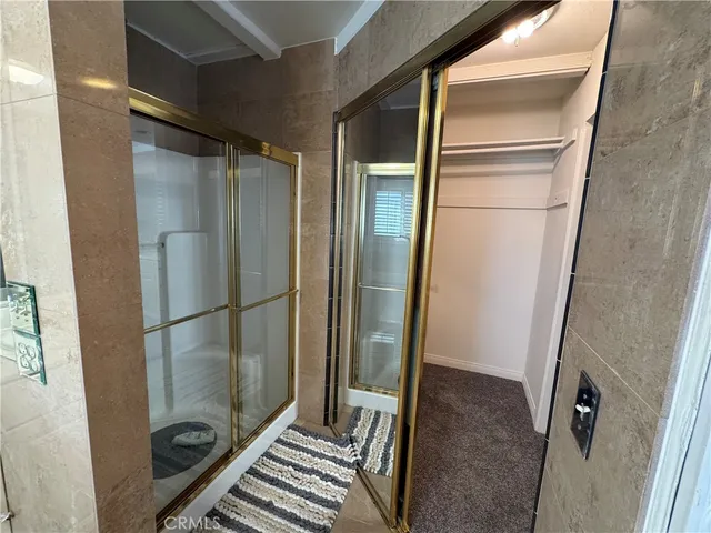 a bathroom with a glass shower door