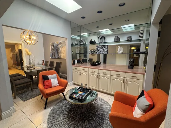 a living room with furniture kitchen and a chandelier