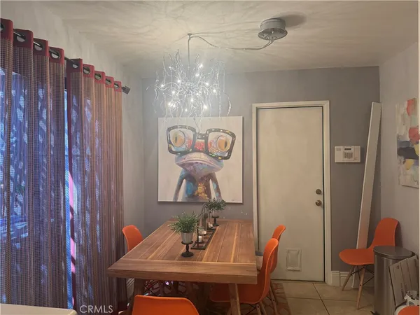 a view of a dining room with furniture and chandelier