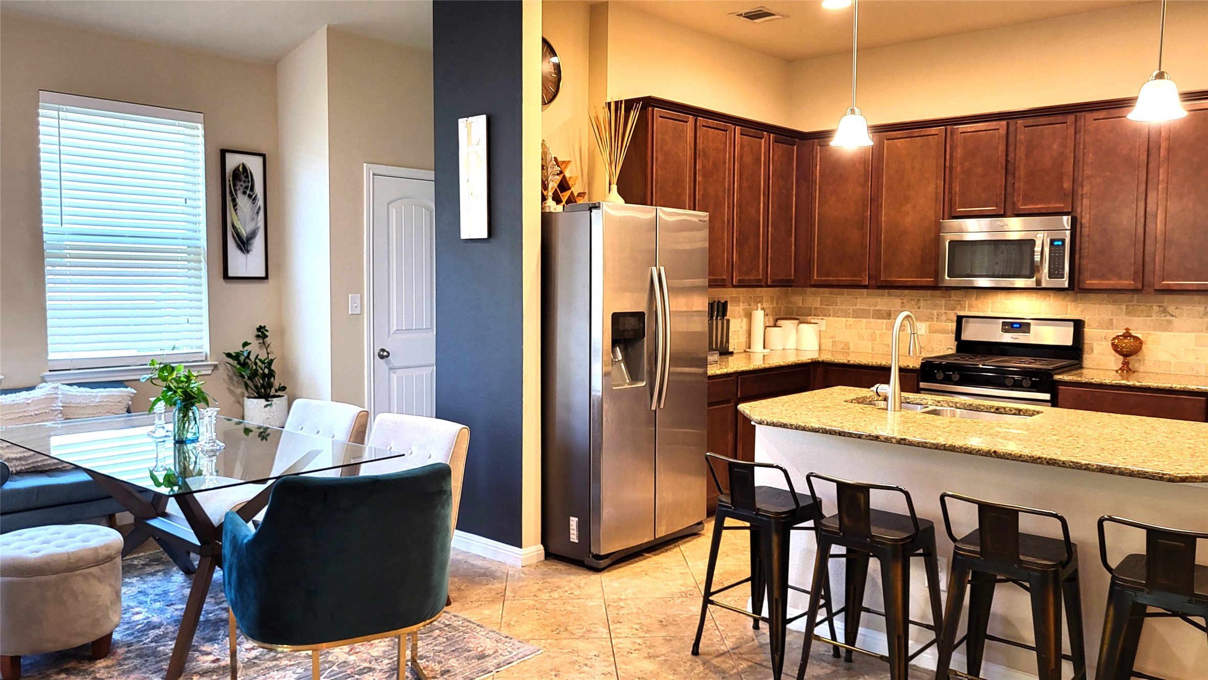 413 Anacua Loop, Unit 8 Manchaca, TX 78652 - Photo 5 of 23 Rich wood cabinetry and a stone-topped island define this open kitchen design.