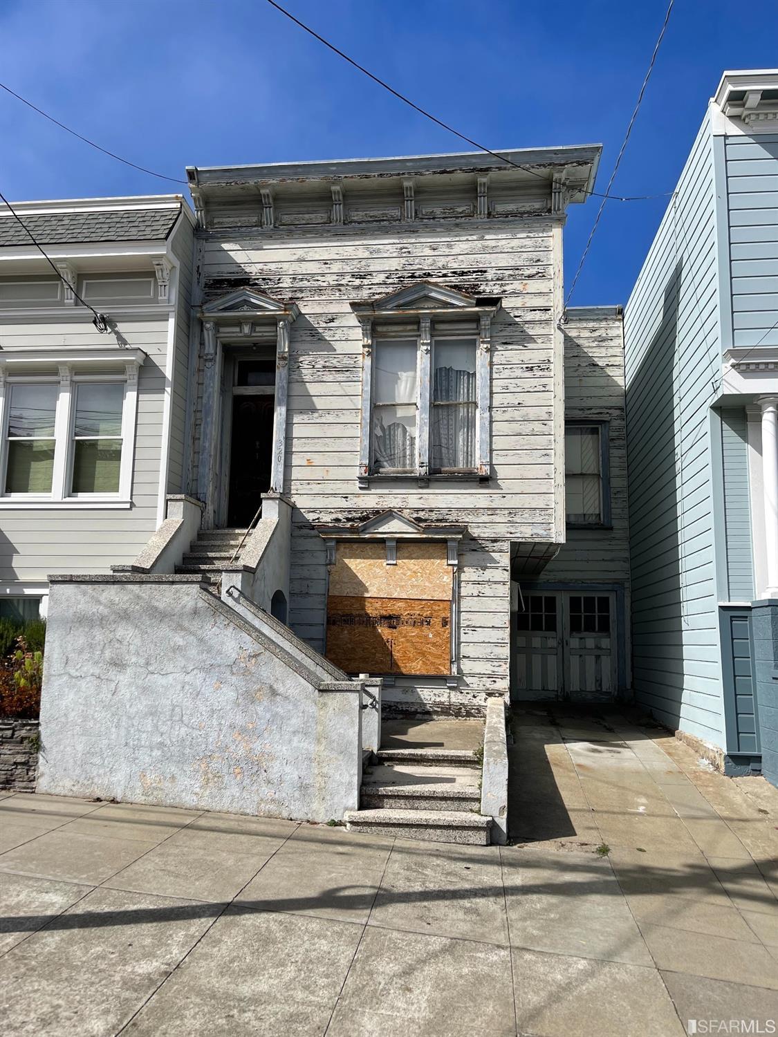 a view of a house with a door and a yard