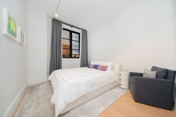 a bedroom with a bed and a couch
