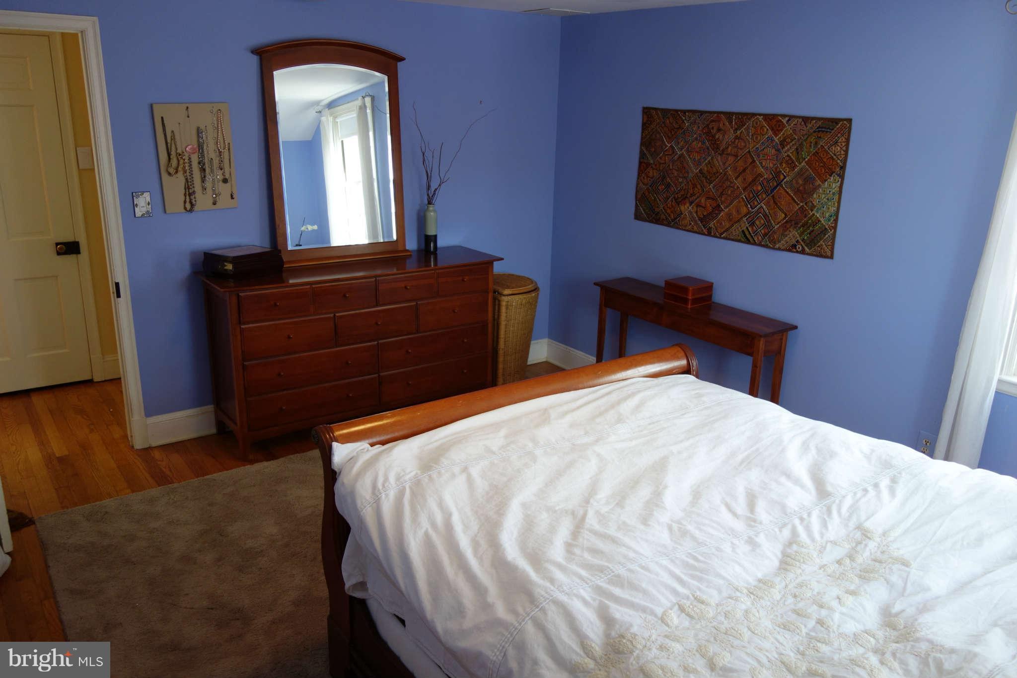 2510 Pickwick Road Baltimore, MD 21207 - Photo 16 of 30 a bedroom with a bed and a mirror on dresser