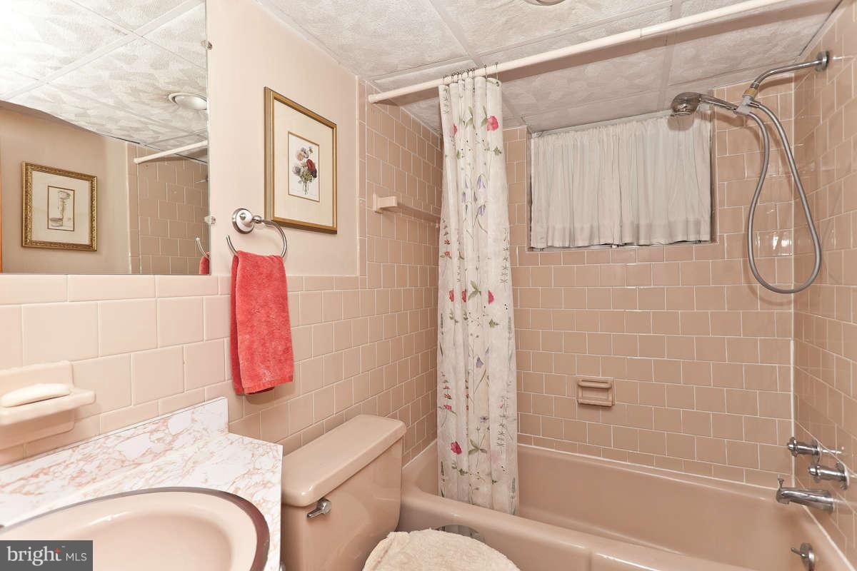 2510 Pickwick Road Baltimore, MD 21207 - Photo 24 of 30 a bathroom with a shower a bath tub and a shower