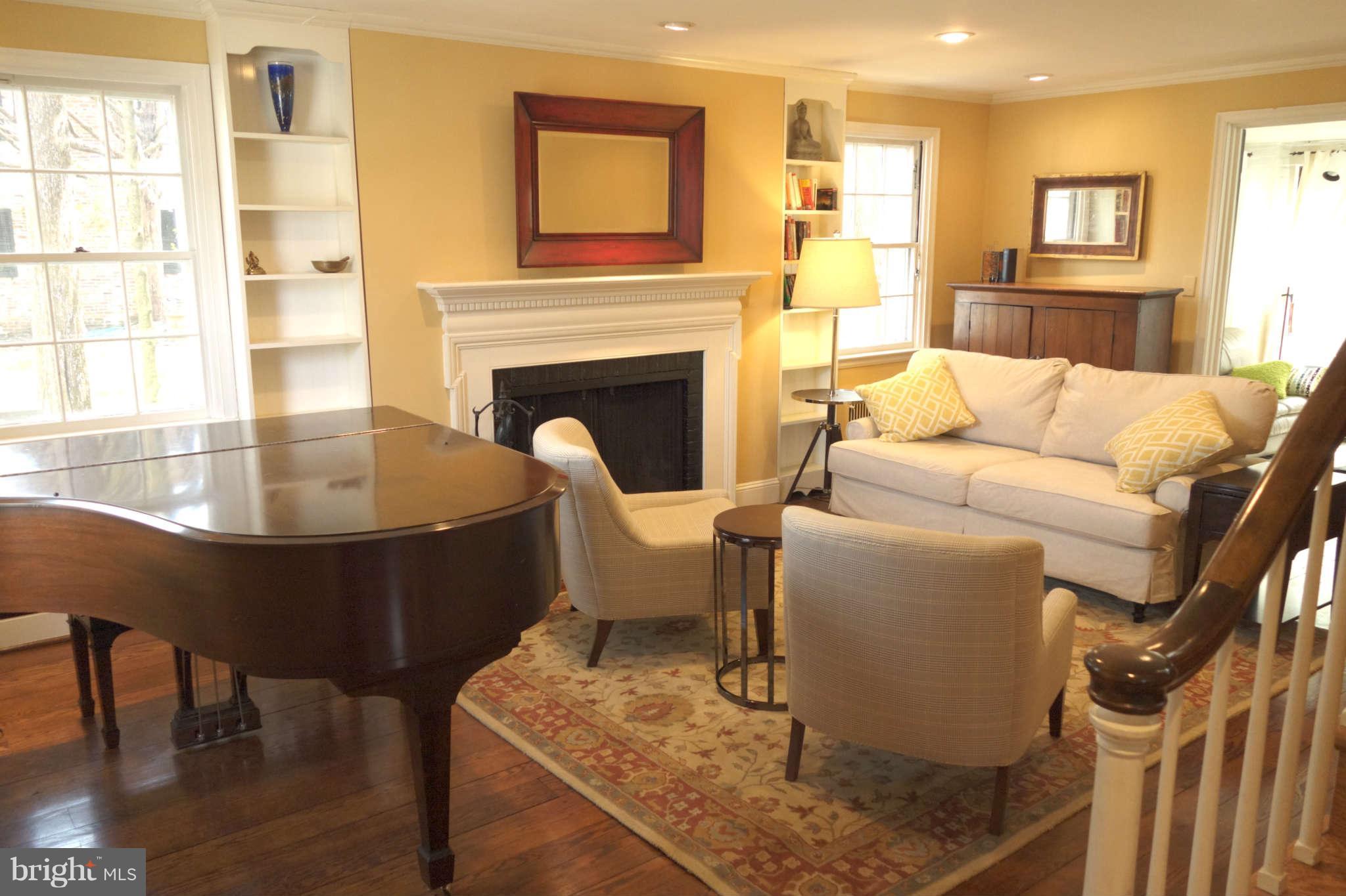 2510 Pickwick Road Baltimore, MD 21207 - Photo 4 of 30 a living room with furniture a table and a fireplace