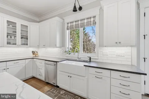 a kitchen with a sink cabinets and window