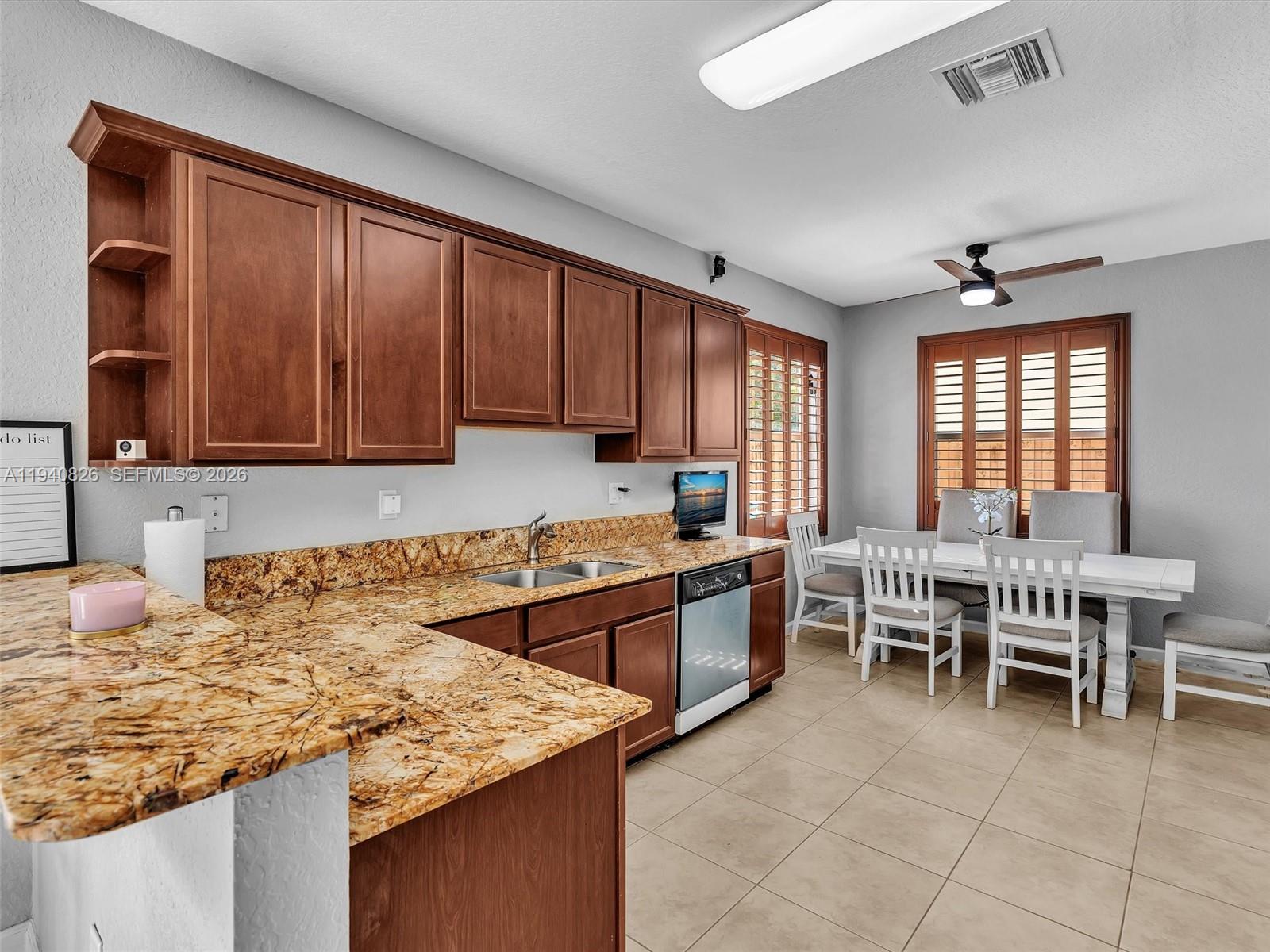 625 Southeast 30th Terrace Homestead, FL 33033 - Photo 15 of 71 a kitchen with granite countertop sink table and chairs