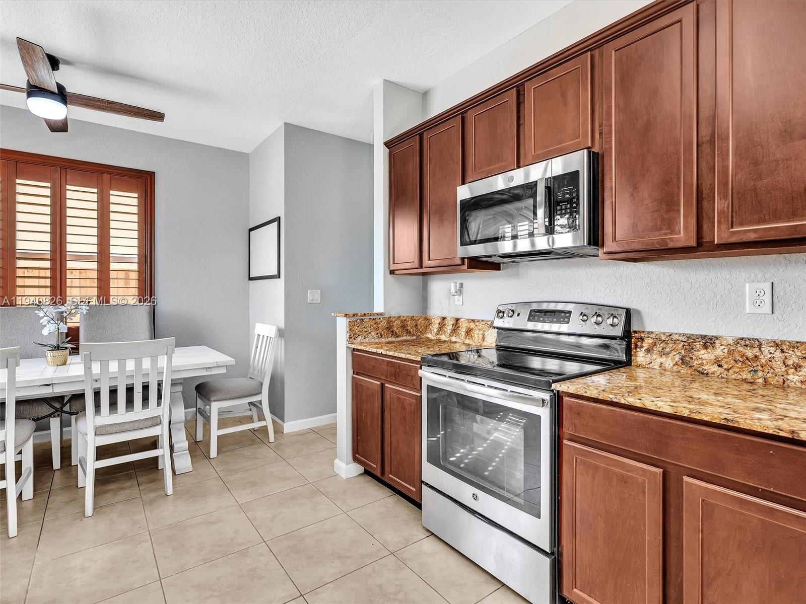 625 Southeast 30th Terrace Homestead, FL 33033 - Photo 16 of 71 a kitchen with stainless steel appliances a stove a sink and a microwave