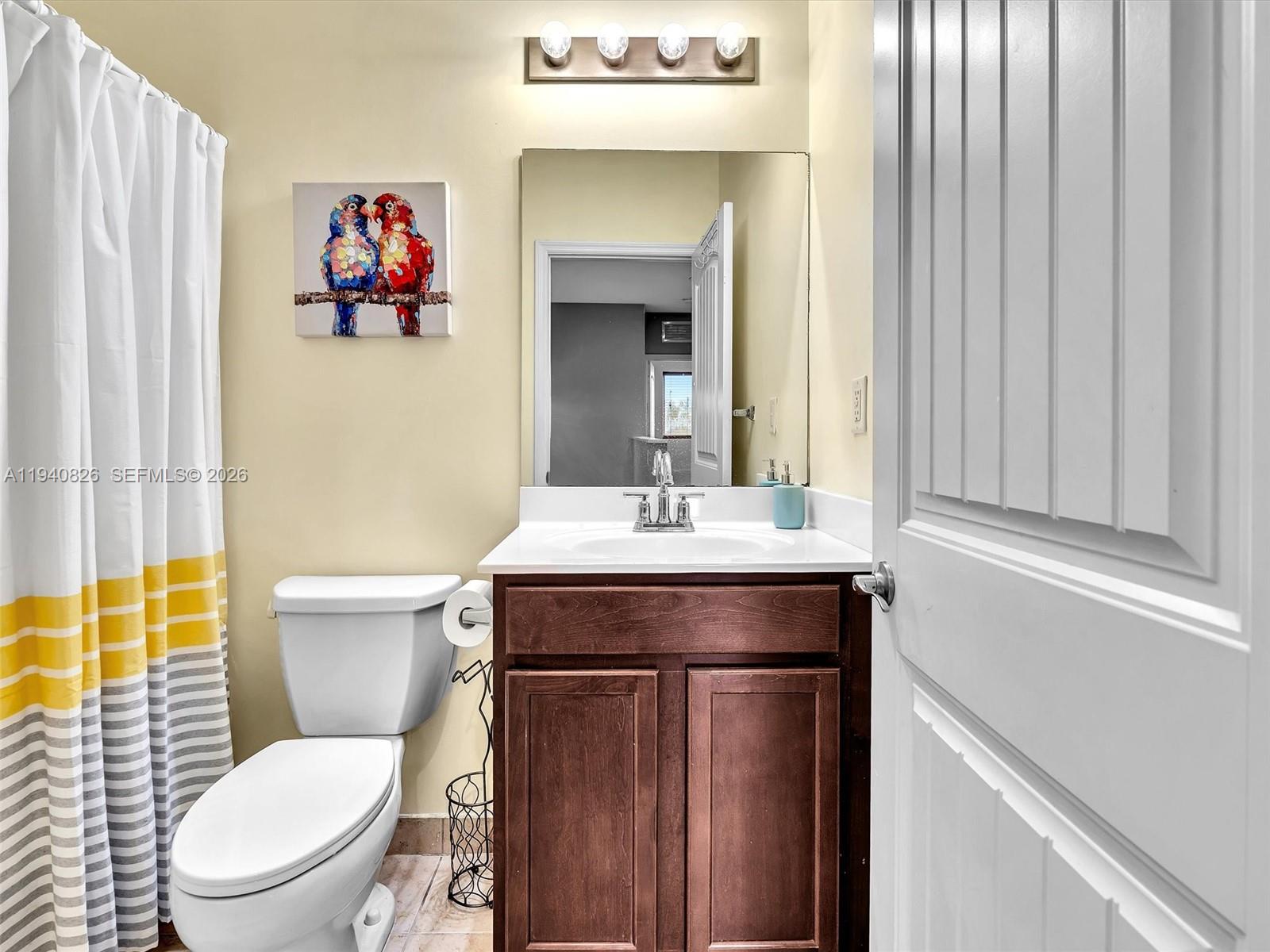 625 Southeast 30th Terrace Homestead, FL 33033 - Photo 24 of 71 a bathroom with a toilet a sink and a mirror