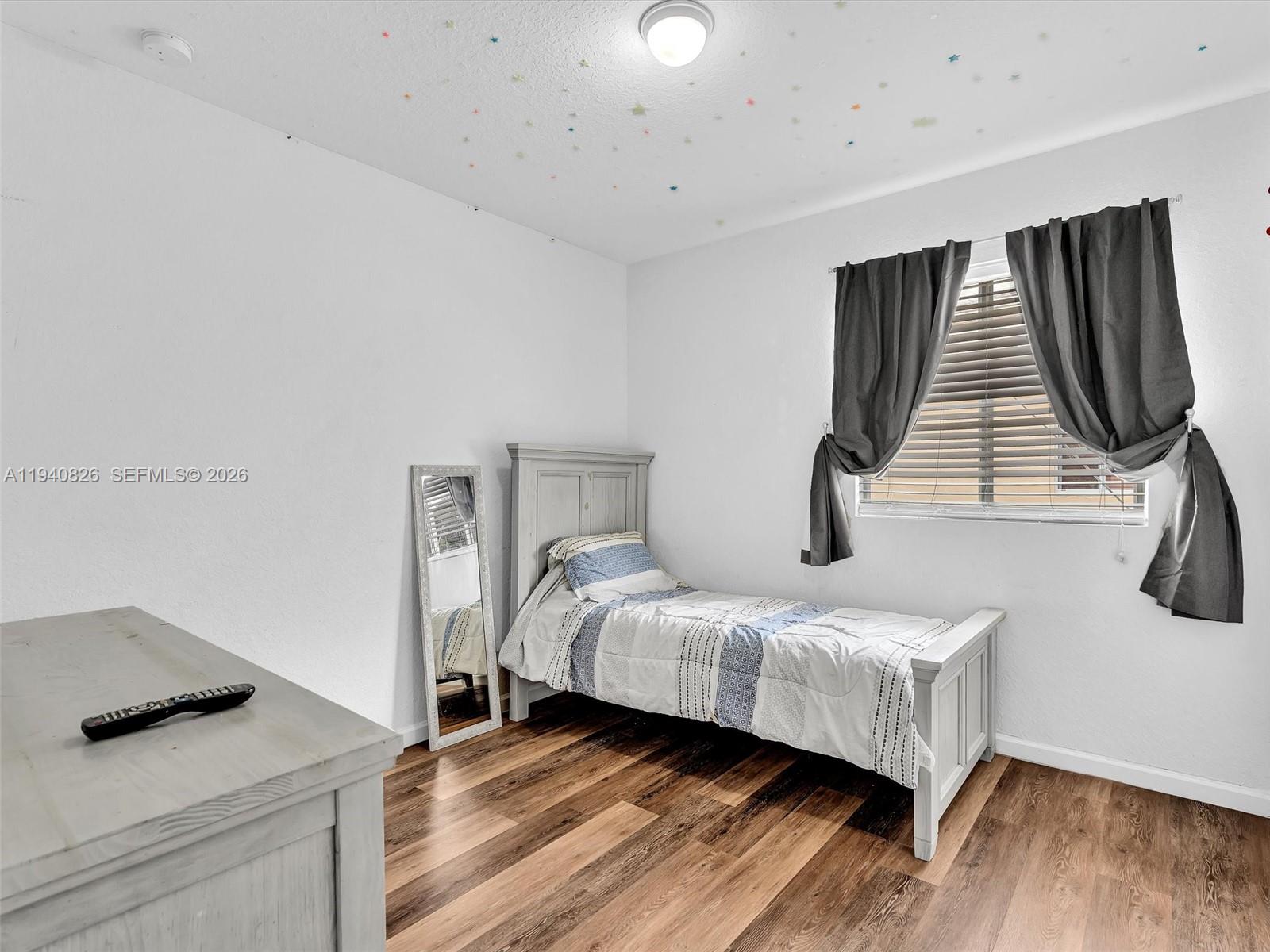 625 Southeast 30th Terrace Homestead, FL 33033 - Photo 27 of 71 a bedroom with a bed and wooden floor