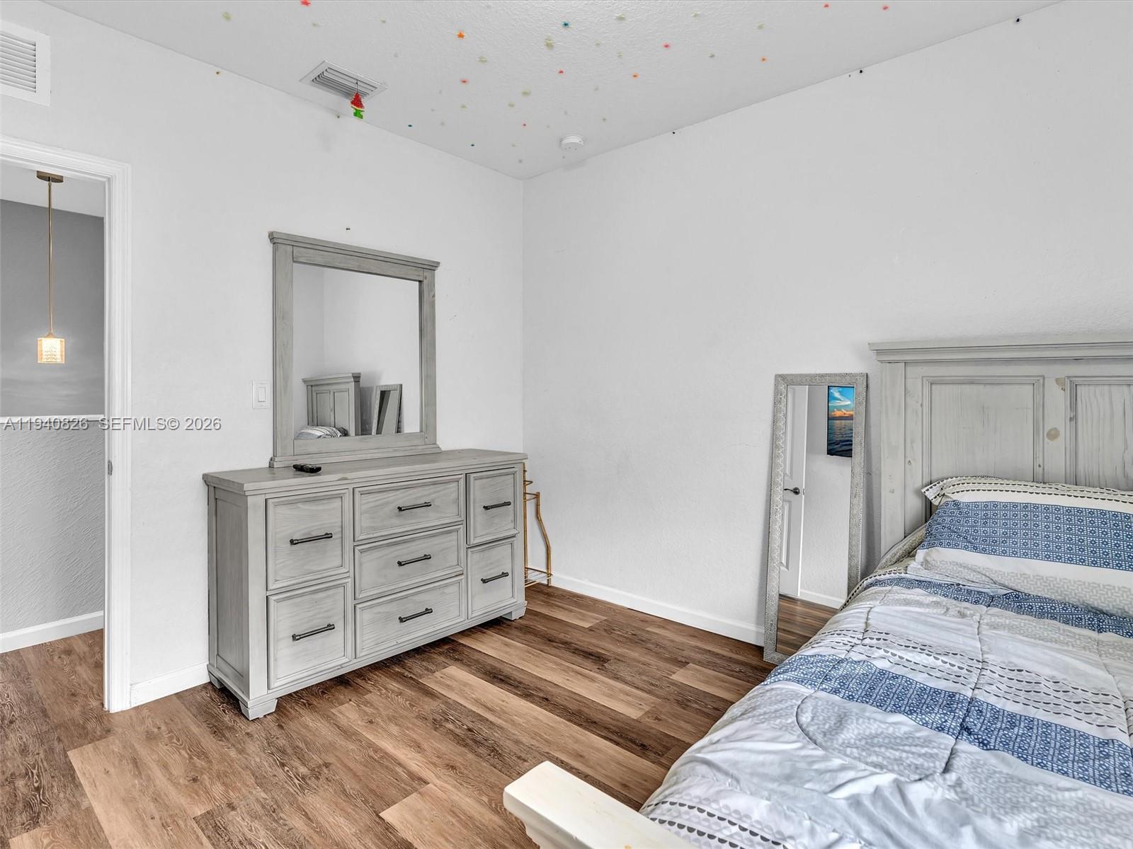 625 Southeast 30th Terrace Homestead, FL 33033 - Photo 28 of 71 a bedroom with a bed and a dresser