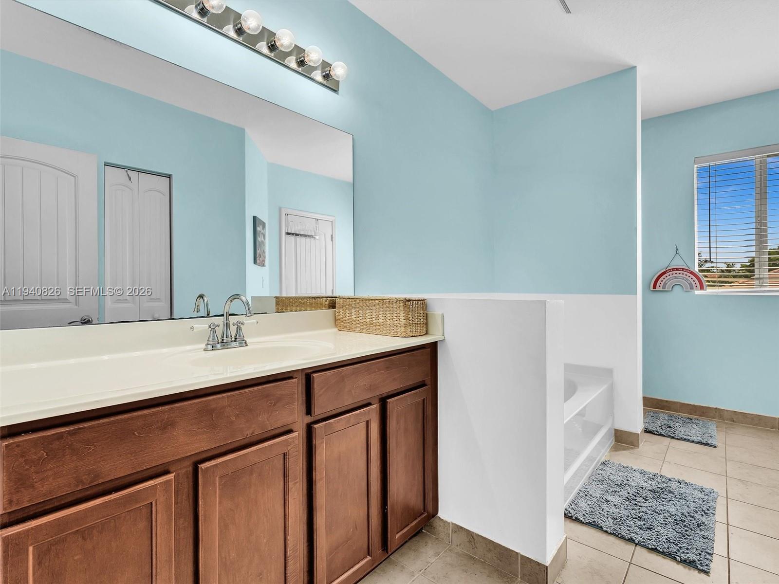 625 Southeast 30th Terrace Homestead, FL 33033 - Photo 34 of 71 a bathroom with a sink and a mirror