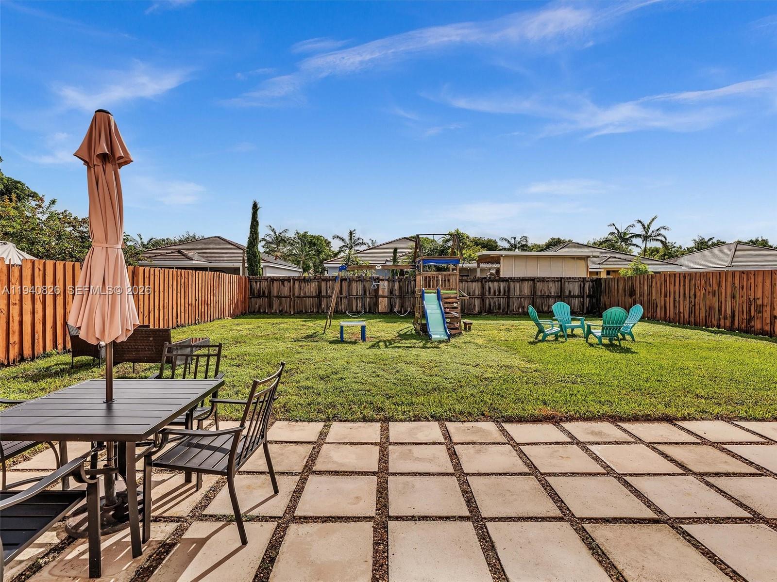 625 Southeast 30th Terrace Homestead, FL 33033 - Photo 6 of 71 a view of a chairs and table in the yard