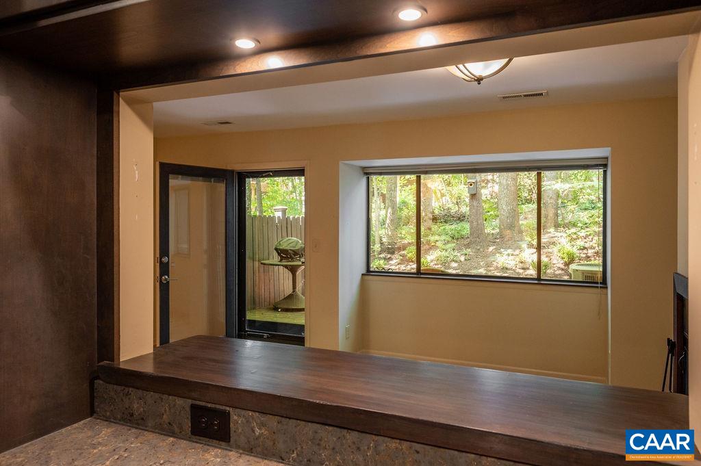 116 Blithe Court Charlottesville, VA 22901 - Photo 13 of 37 View from the kitchen sink into the living room and the patio beyond.