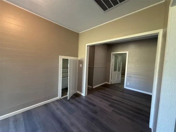 a room with stainless steel appliances kitchen island granite countertop a sink and cabinets