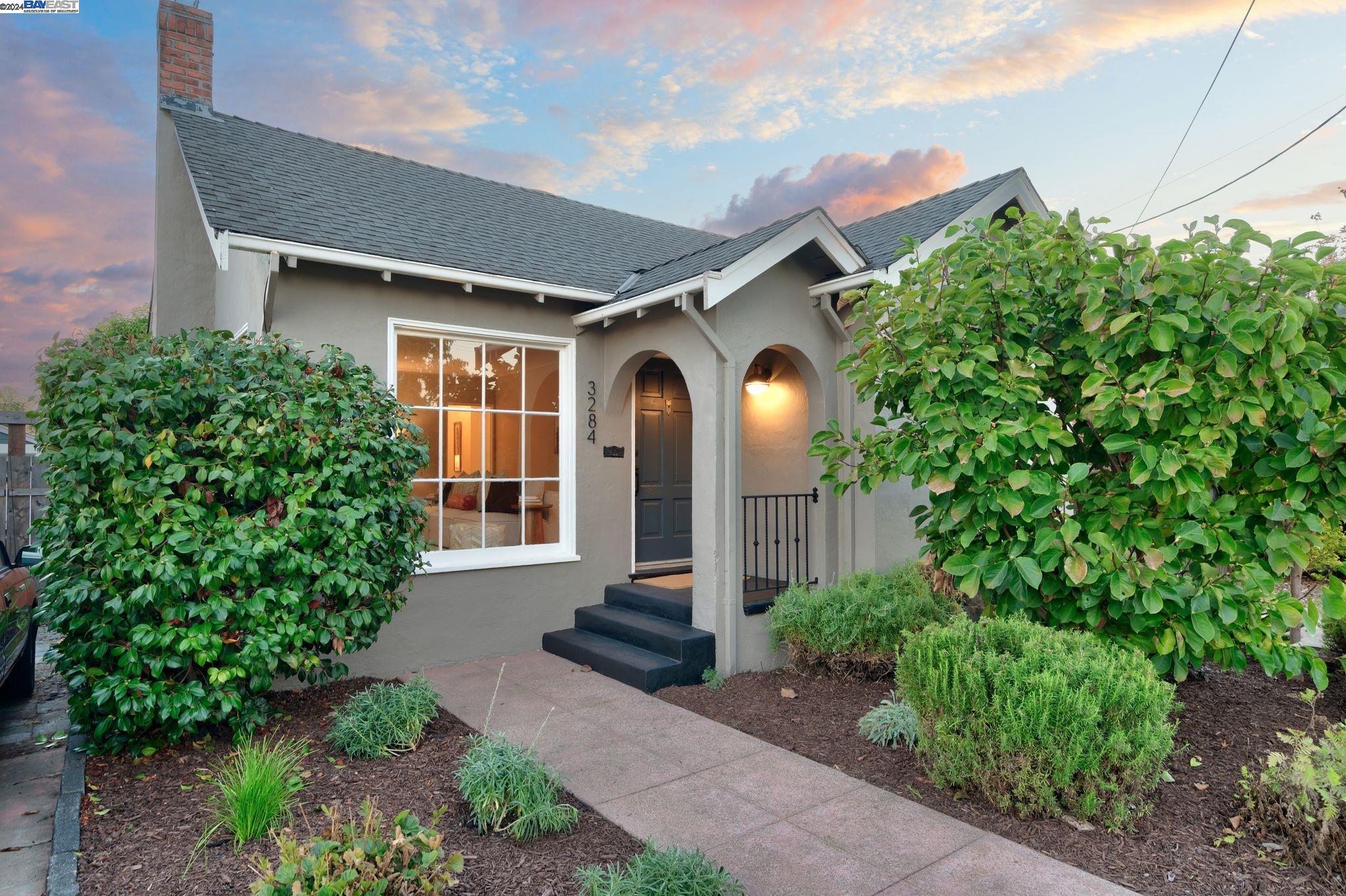 a front view of a house with garden