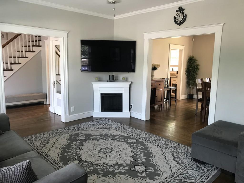 15 Fair Street Hull, MA 02045 - Photo 5 of 8 a living room with a flat screen tv and a fireplace