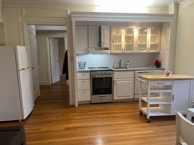 a kitchen with a sink stove and cabinets