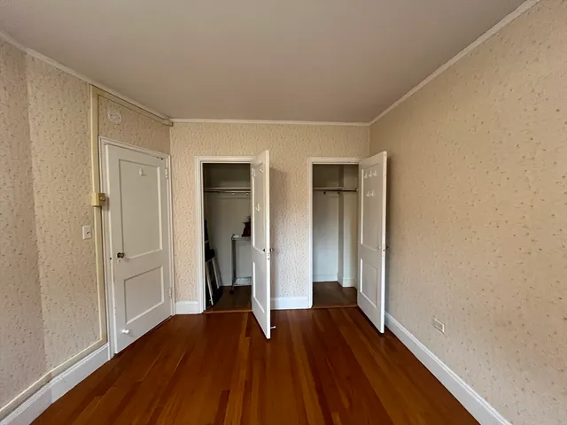a view of hallway with wooden floor