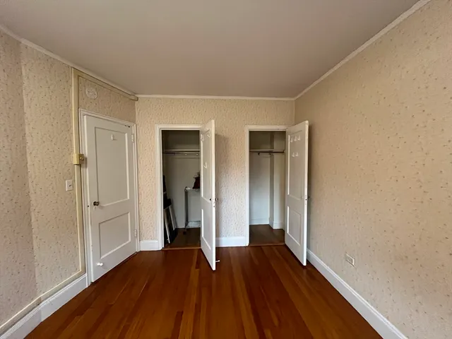 a view of hallway with wooden floor
