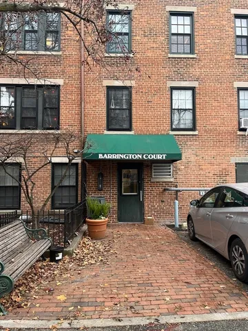 a view of a car parked in front of a brick building