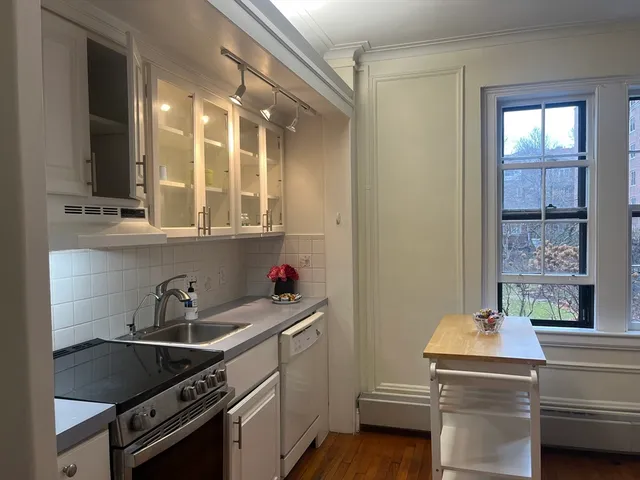 a kitchen that has a sink and a stove