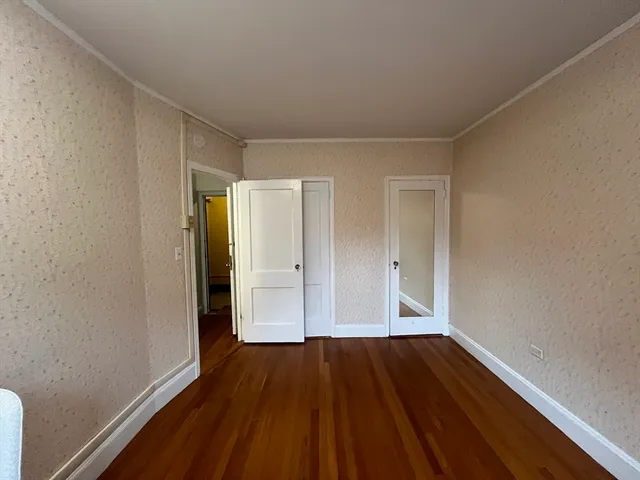 a view of a room with wooden floor