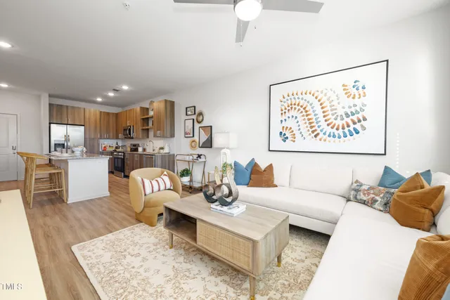 a living room with furniture and kitchen view