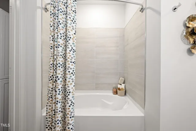 a bathroom with a bathtub and shower