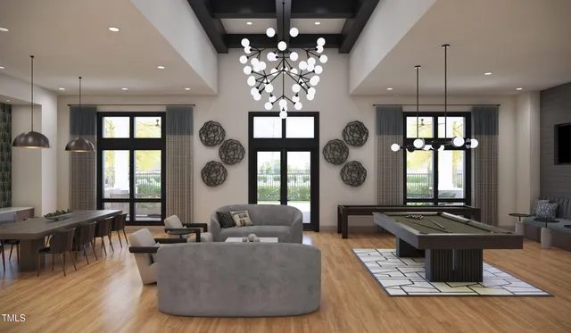 a living room with furniture large window and wooden floor