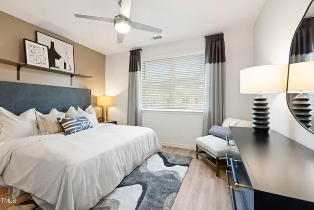 a bedroom with a bed and wooden floor