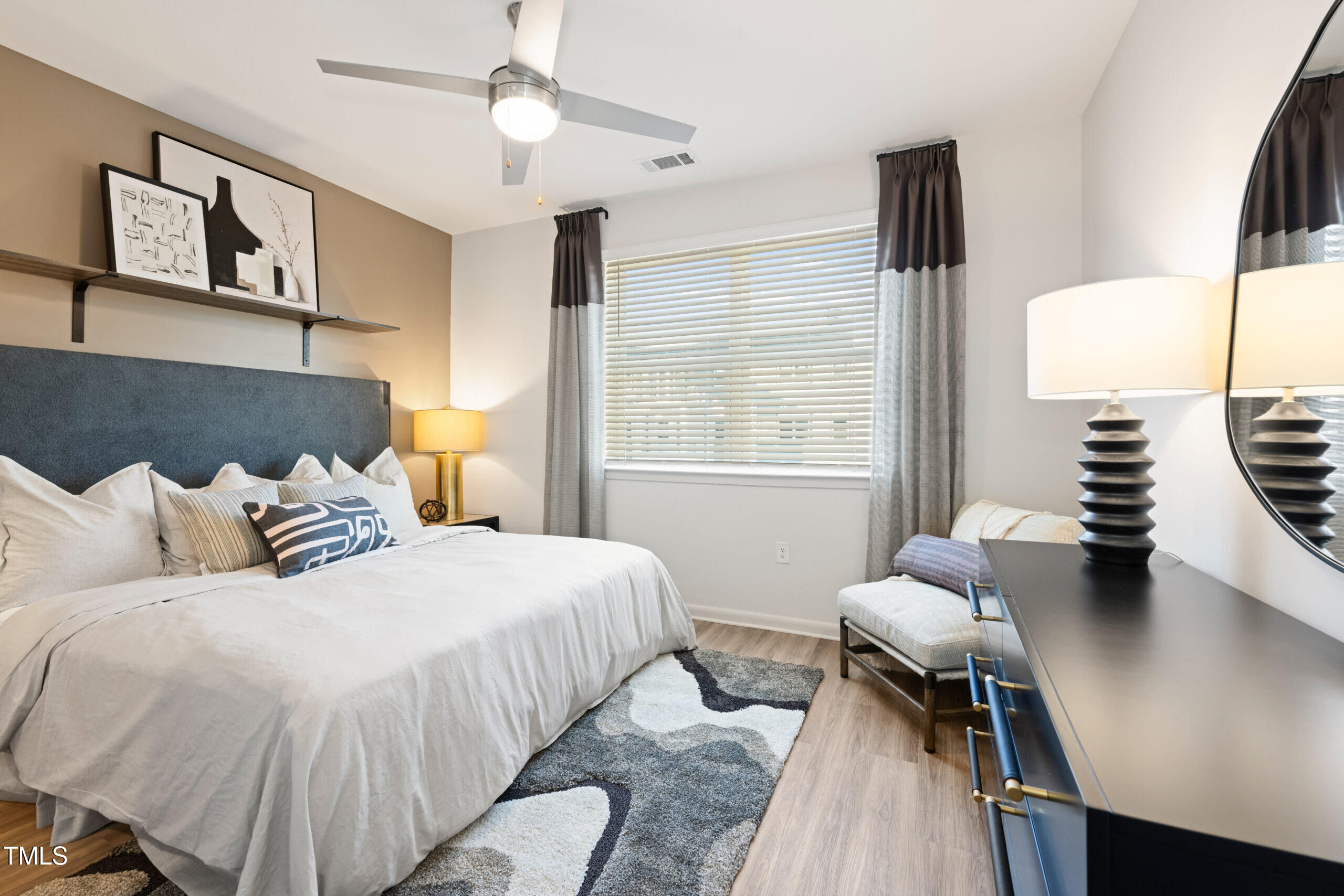 211 Hammond Center Drive, Unit A1 Raleigh, NC 27603 - Photo 26 of 30 a bedroom with a bed and wooden floor