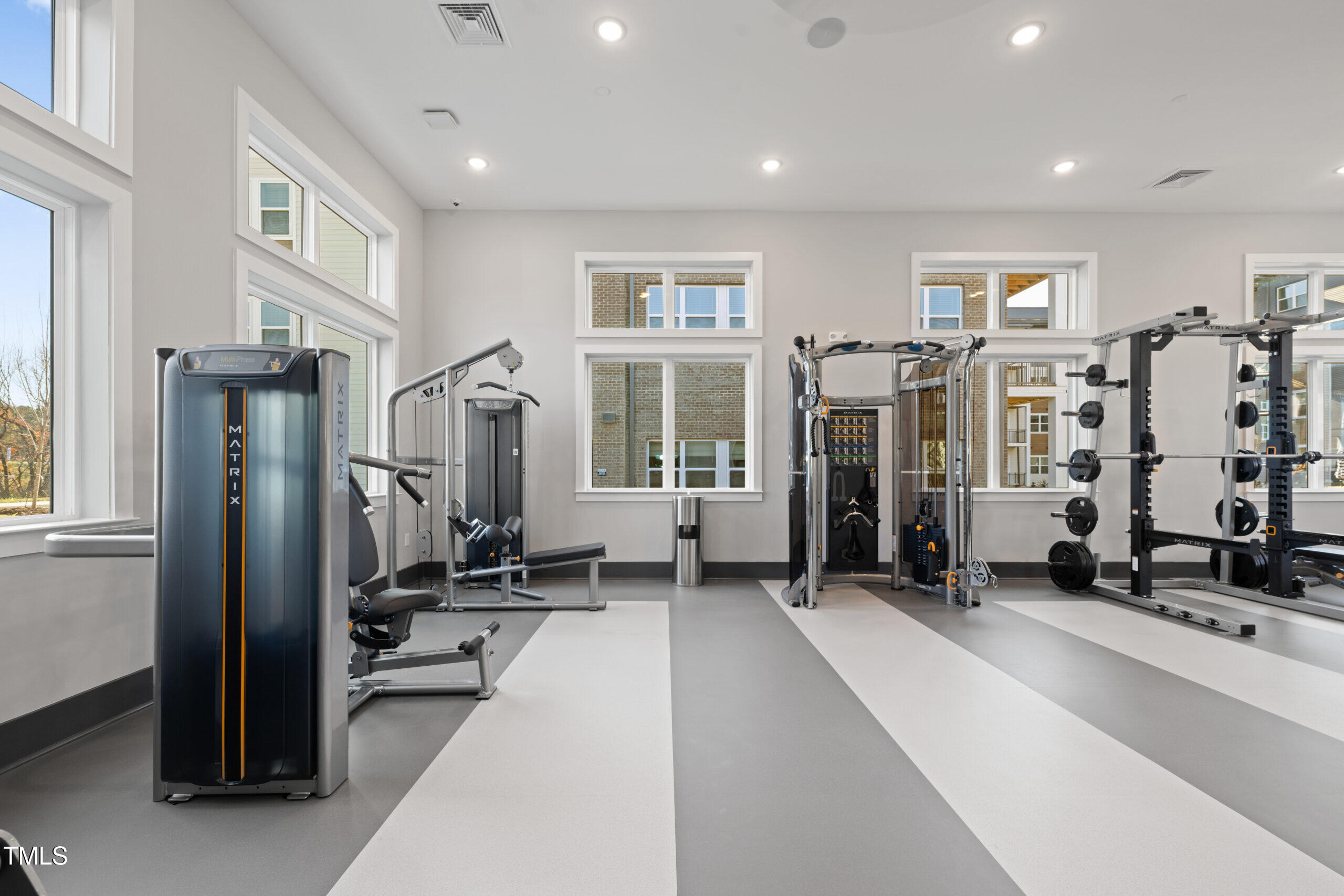 211 Hammond Center Drive, Unit A1 Raleigh, NC 27603 - Photo 5 of 30 a living room with furniture gym equipment and a large window