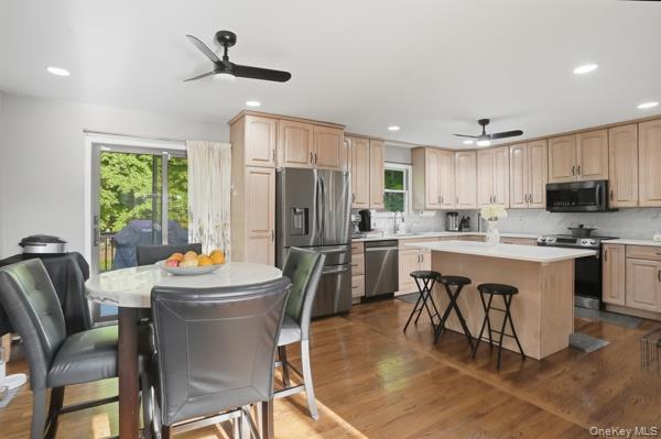 31 Laura Road Monroe, NY 10950 - Photo 15 of 39 a kitchen with a refrigerator a stove a sink dishwasher with a dining table and chairs