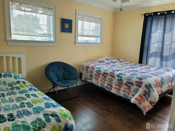 a bedroom with a bed a dresser and chair
