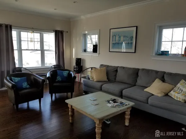 a living room with furniture and a hard wood floor